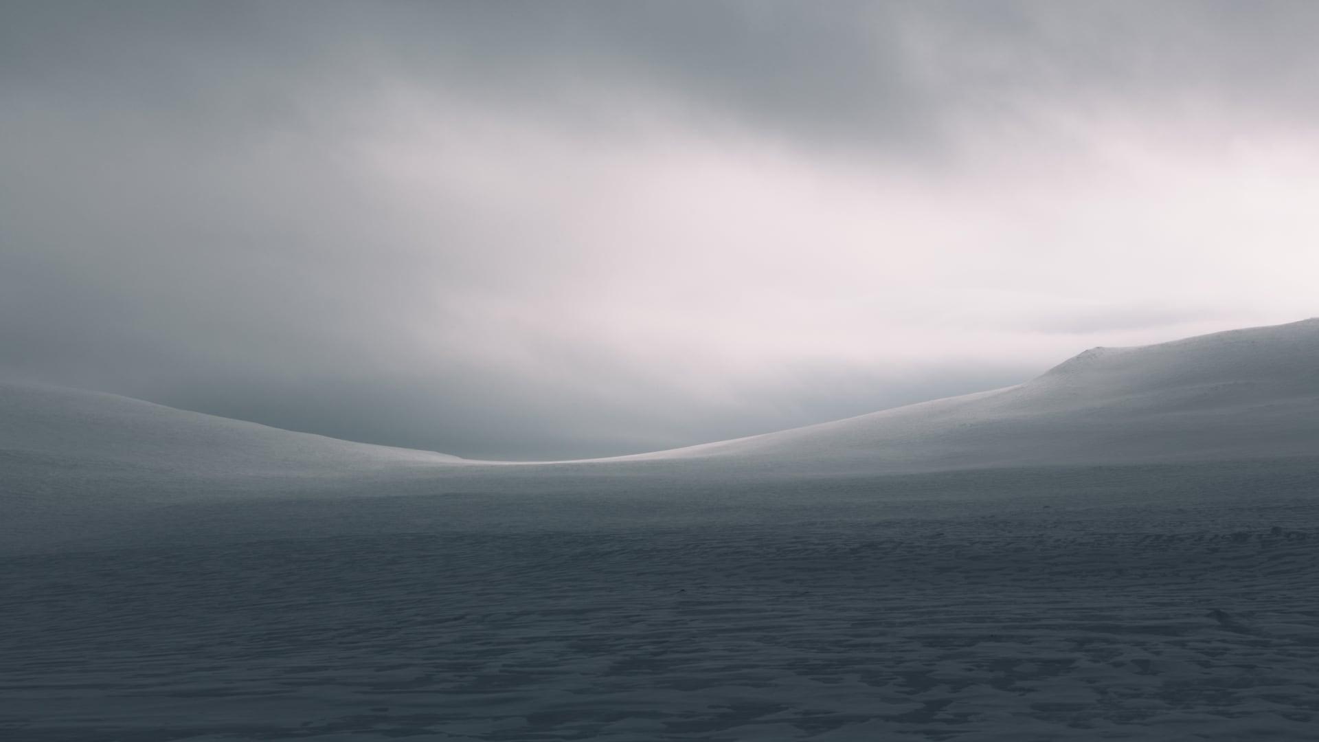 Snow-covered hills under a cloudy sky in Finland